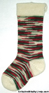 Holly & Ivy Multi knitted Christmas stocking with Ivory trim cuff, heel and toe