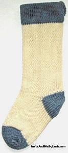 Ivory knitted Christmas stocking with Country Blue cuff, heel and toe