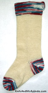 Ivory knitted Christmas stocking with Wedgewood Multi-color cuff, heel and toe