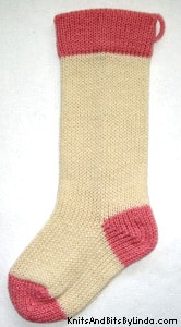 Ivory knitted Christmas stocking with Rose Pink cuff, heel and toe