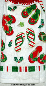 pairs of flip flops decorated for Christmas on hanging kitchen hand towel