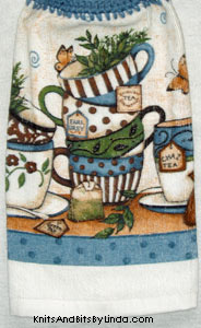 stack of tea cups on hanging hand towel