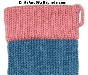 country blue stocking with rose pink yarn trim